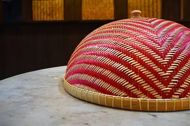 Photo of Cone-shaped food cover on marble dining table