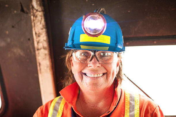 Mature Woman Underground Miner with Headlamp. stock photo