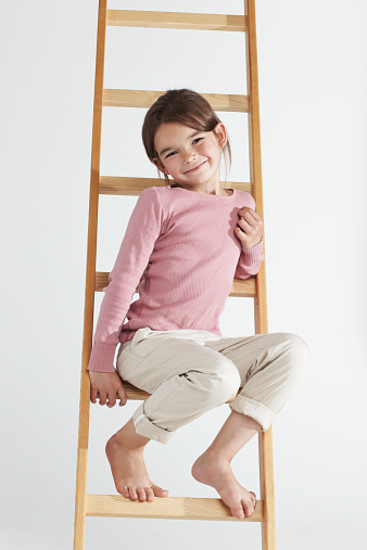 Studio portrait of an cute little girl sitting on a ladderhttp://195.154.178.81/DATA/istock_collage/438863/shoots/782555.jpg