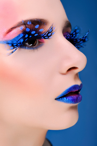 woman portrait, close-up with feather falase eyelashes.