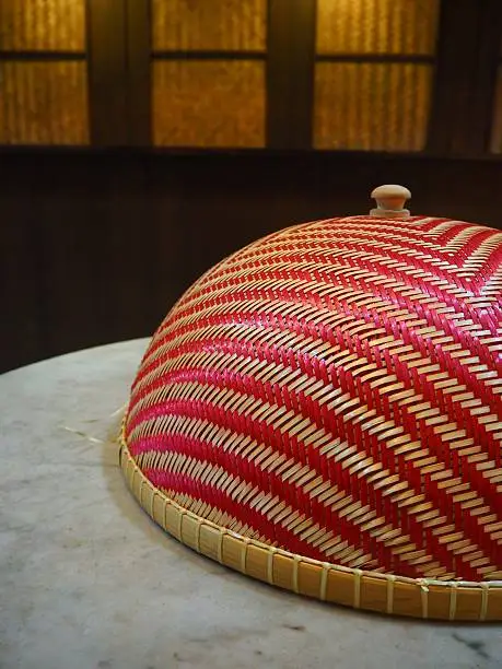 Photo of Cone-shaped food cover on grey marble dining table