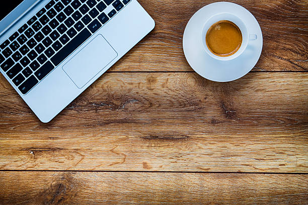 istock Laptop over on wooden table 536844582