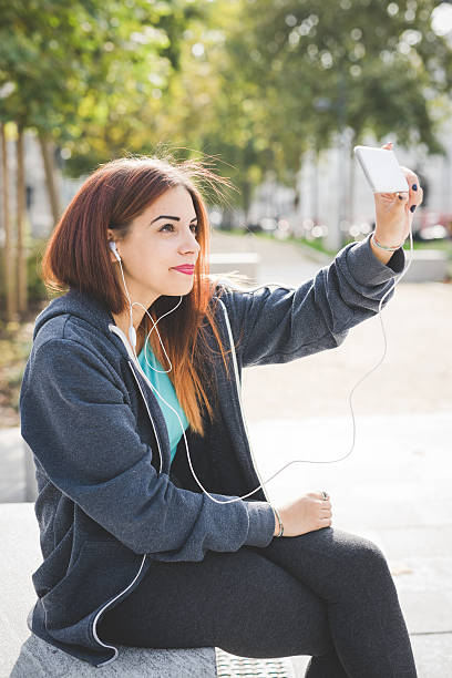 istock young beautiful woman taking selfie 536847122