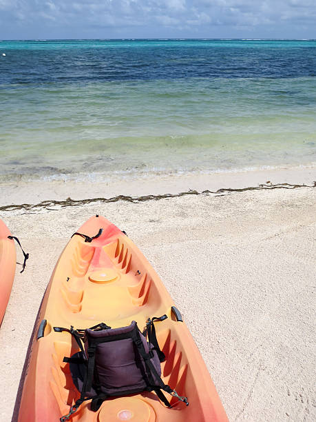 istock Orange sea kayak parked on the beach in Belize 536847282