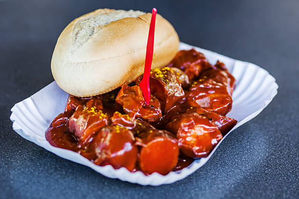 berlin currywurst in a carboard tray - currywurst stock-fotos und bilder