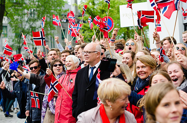 People in Bergen during Constitution Day 17th of May Bergen, Norway - May 17, 2016: People in Bergen, Norway during Constitution Day (17th of May). Adults and children are dressed up in traditional dresses (bunad) and waiving flags at the passing procession. number 17 stock pictures, royalty-free photos & images