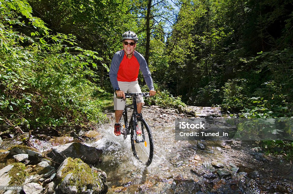 Mountain biker crossing water 2015 Stock Photo