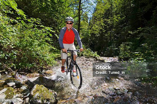 Mountain Biker Crossing Water Stock Photo - Download Image Now - 2015, Activity, Adult