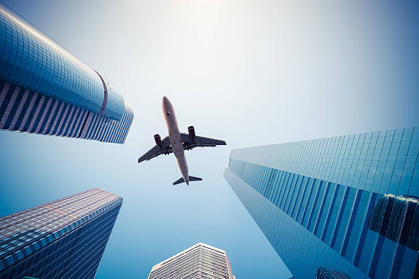 istock upward view of airplane and modern building 536854917