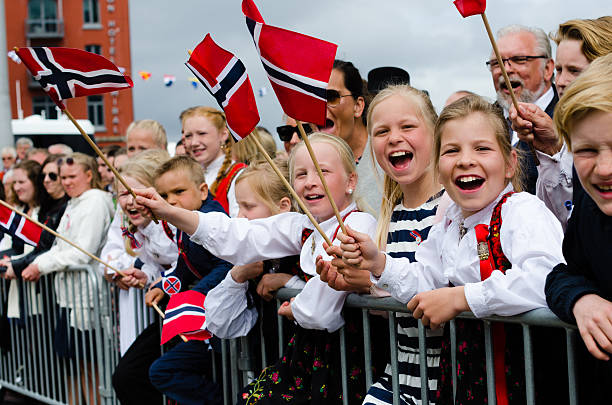 People in Bergen during Constitution Day 17th of May Bergen, Norway - May 17, 2016: People in Bergen, Norway during Constitution Day (17th of May). Adults and children are dressed up in traditional dresses (bunad) and waiving flags at the passing procession. number 17 stock pictures, royalty-free photos & images