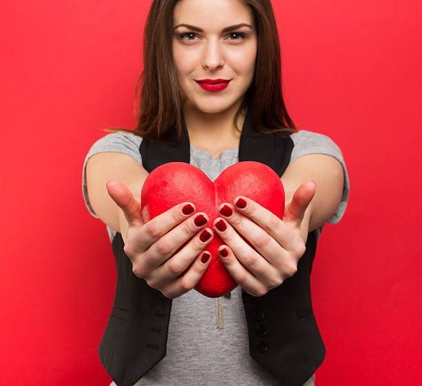 istock Beautiful woman with red heart 536855383