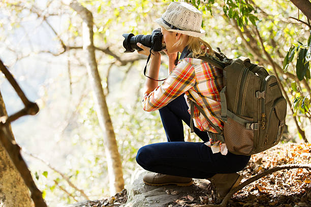 istock young woman taking photos in forest 536874489