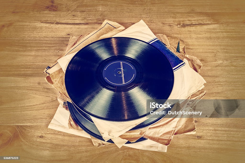 Collection of old vinyl record lp's with sleeves Retro styled image of a collection of old vinyl record lp's with sleeves on a wooden background 2015 Stock Photo