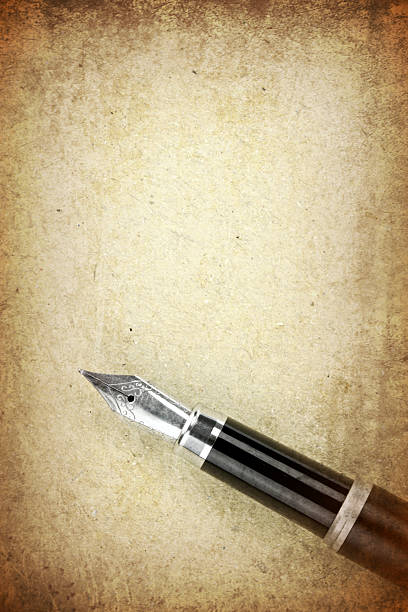 istock Fountain pen on a old brown paper 536875852