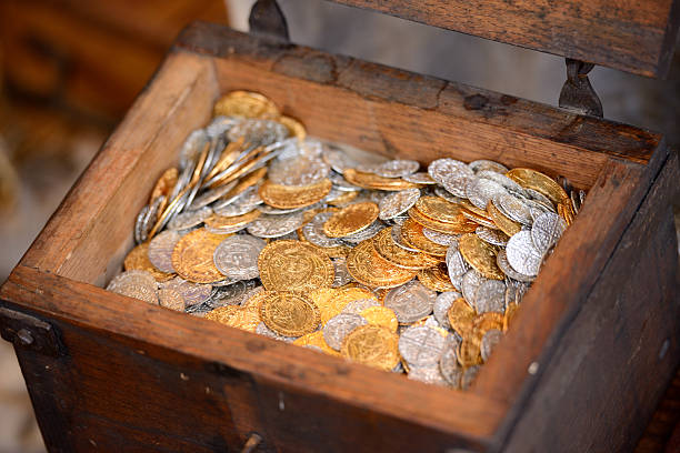 Treasure chest Old wooden treasure chest full of coins opening a gold ira stock pictures, royalty-free photos & images