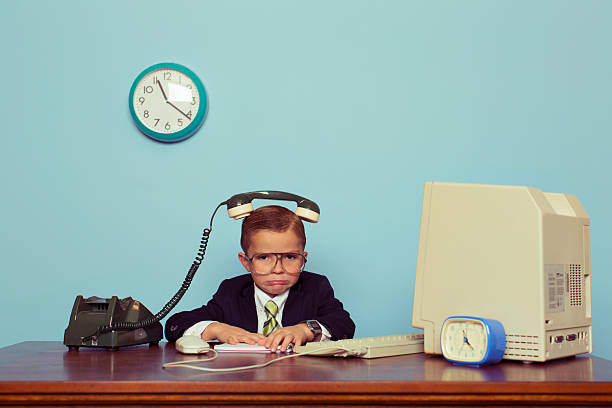 Young Boy Businessman with Telephone on His Head A young boy and businessman is frustrated with the telephone on his head. He is not sure how to solve complex business problems. Retro styled. irritation photos stock pictures, royalty-free photos & images