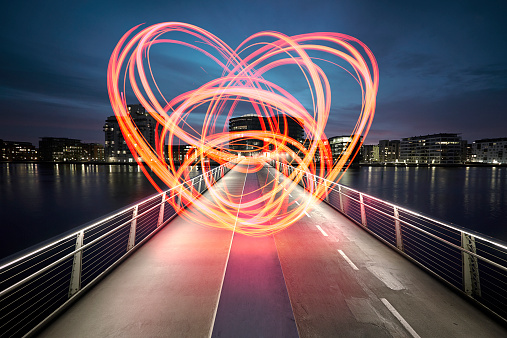 Large heart drawn with light on a bridge connecting the two sides of the harbor. Love for the city we live in. Love sign