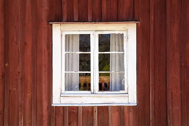Photo of Old wooden wall with window in white frame
