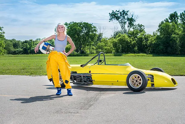 Female driver standing with a 1977 "Formula Ford" class racecar.