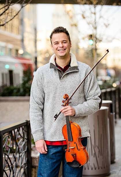 istock Attractive Man Outdoors Smiling With Violin 536890025