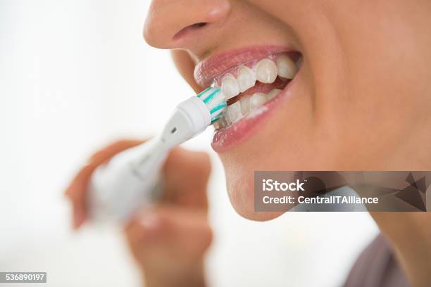 Closeup On Young Woman Brushing Teeth Stock Photo - Download Image Now - Brushing Teeth, Brushing, Electric Toothbrush