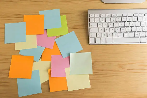 Full of post it on the desk. Space for your text. Busy, hard and stessful job concept.