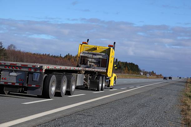 istock Semi-truck on a highway with a flat bed trailer 536893417