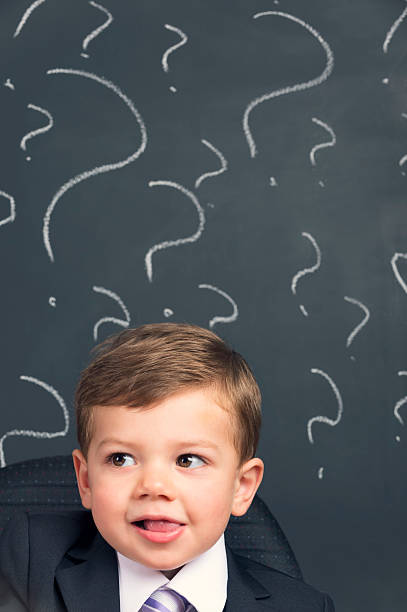 istock Humorous Decision making concept. Young child in a suit thinking 536893691