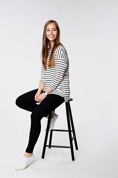 Beautiful woman sitting on stool, portrait