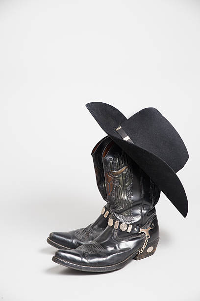 istock Black men´s cowboy boots with a hat 536917955