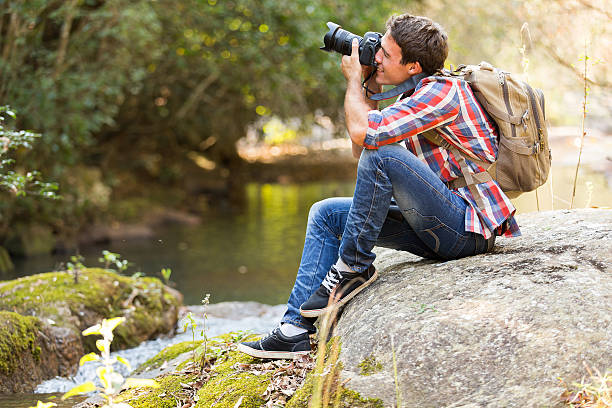 istock photographer photographing in mountain valley 536918069