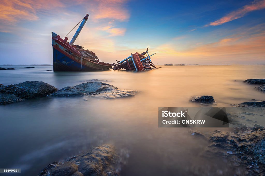 Broken ship in the sea The broken / wreak ship in the sea with the rock and sunset light 2015 Stock Photo