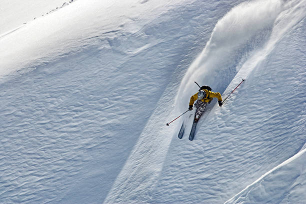 free ride skier turning in powder snow