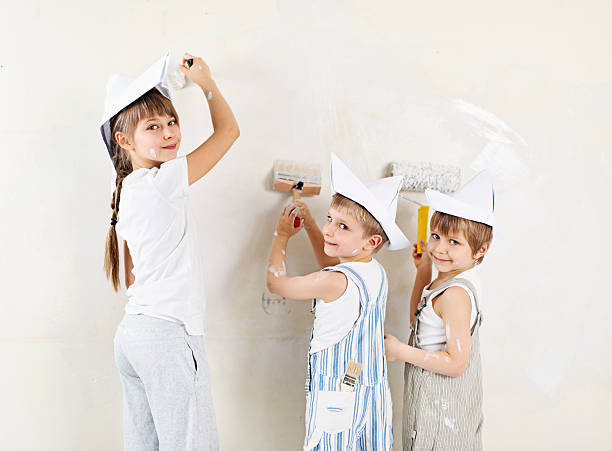 Kids painting their home