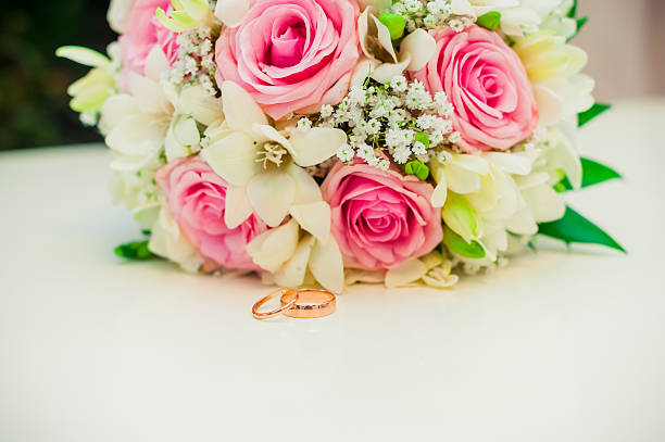 istock wedding rings on a white background with a bouquet 536922427