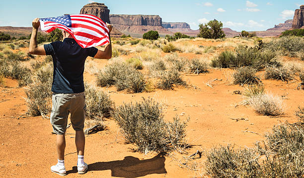 istock Tourist with flag on Monument valley National park 536923745