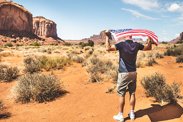 istock Tourist with flag on Monument valley National park 536923747
