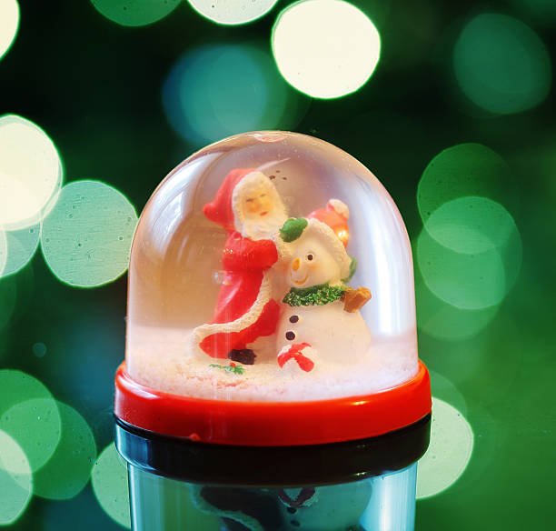 istock Snowing dome with green abstract background at christmas 536937678
