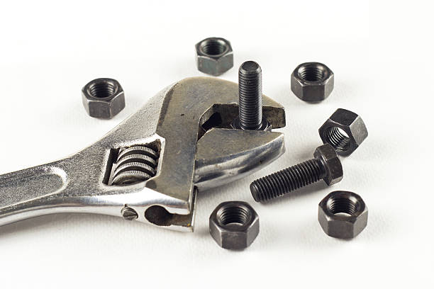 istock Metal wrench with nuts and bolts on white 536944878
