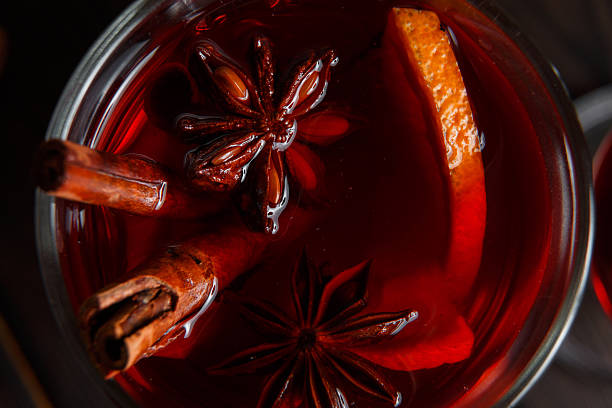 Mulled wine on the dark old wood background Mulled wine with spices on the dark background mulled wine photos stock pictures, royalty-free photos & images