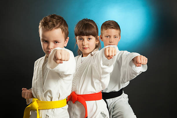 Karate Kids karate martial arts in studio martial arts stock pictures, royalty-free photos & images