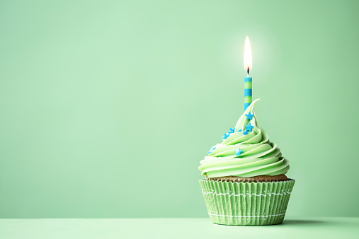 Green birthday cupcake with copy space to side
