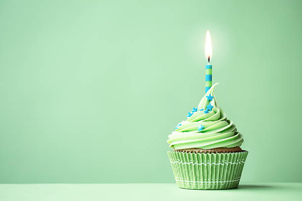 Green birthday cupcake Green birthday cupcake with copy space to side cupcake stock pictures, royalty-free photos & images