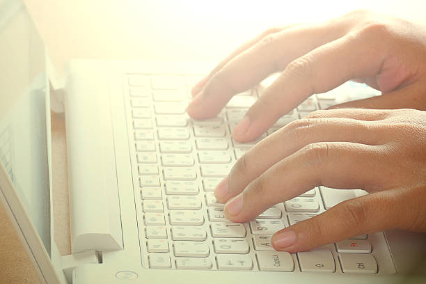 Hands typing on computer keyboard. Close up hands typing on computer keyboard. enter key computer keyboard computer key white stock pictures, royalty-free photos & images