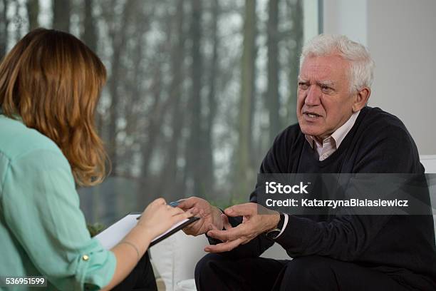 Elderly Patient Talking With Psychotherapist Stock Photo - Download Image Now - 2015, Adult, Care