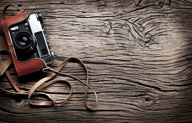 istock Old camera on the old wooden table. 536951613