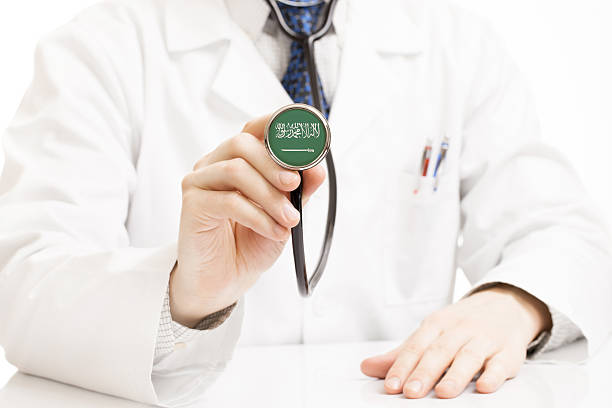 Doctor holding stethoscope with flag series - Saudi Arabia stock photo