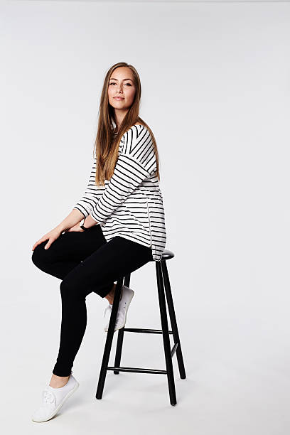 istock Confident woman sitting on stool, portrait 536956862