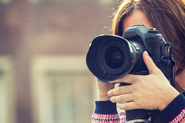 istock Female photographer taking photos using dslr 536959456