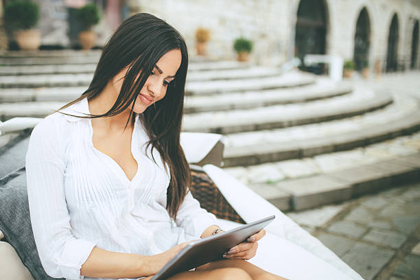 istock beautiful young woman using digital tablet 536964750